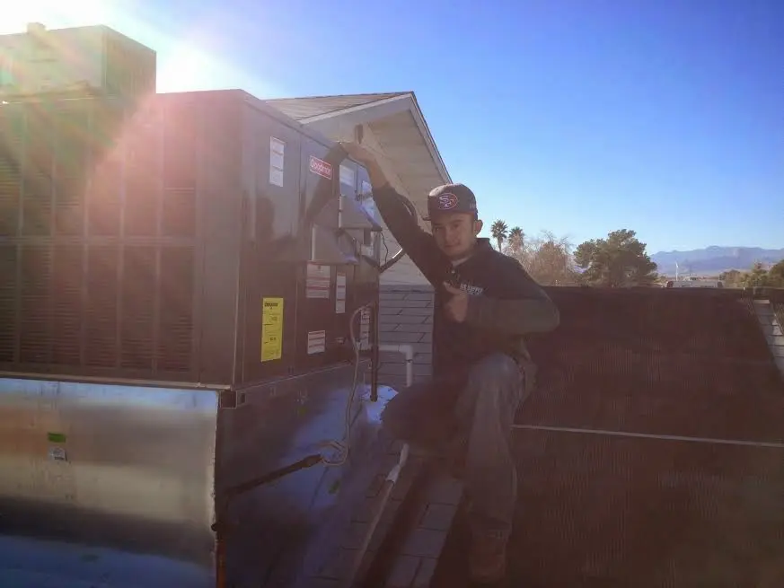 HVAC technician performing HVAC Inspection on a rooftop unit in Redondo Beach